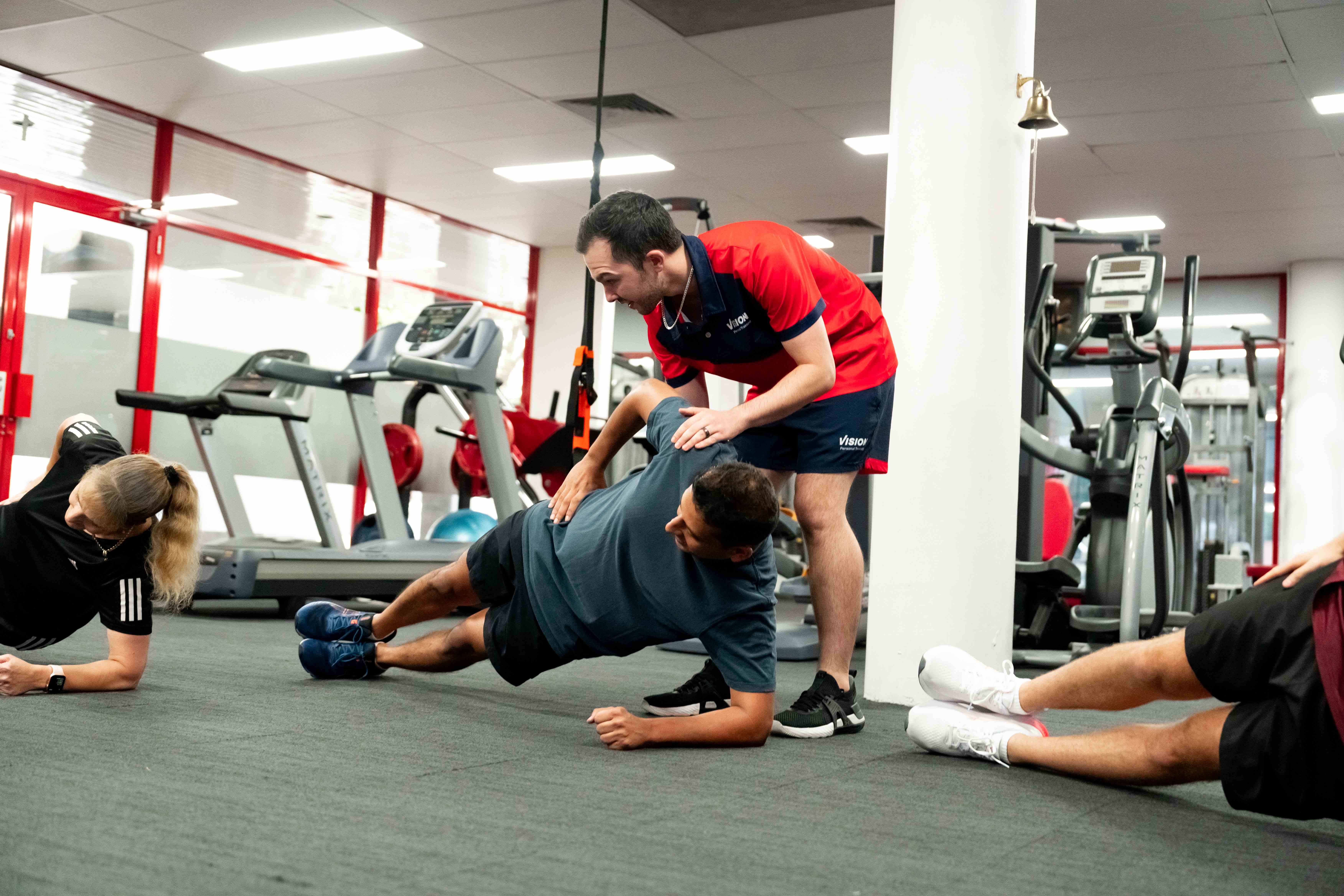 Vision Personal Training clients participating in a group workout, building social wealth through community connections.