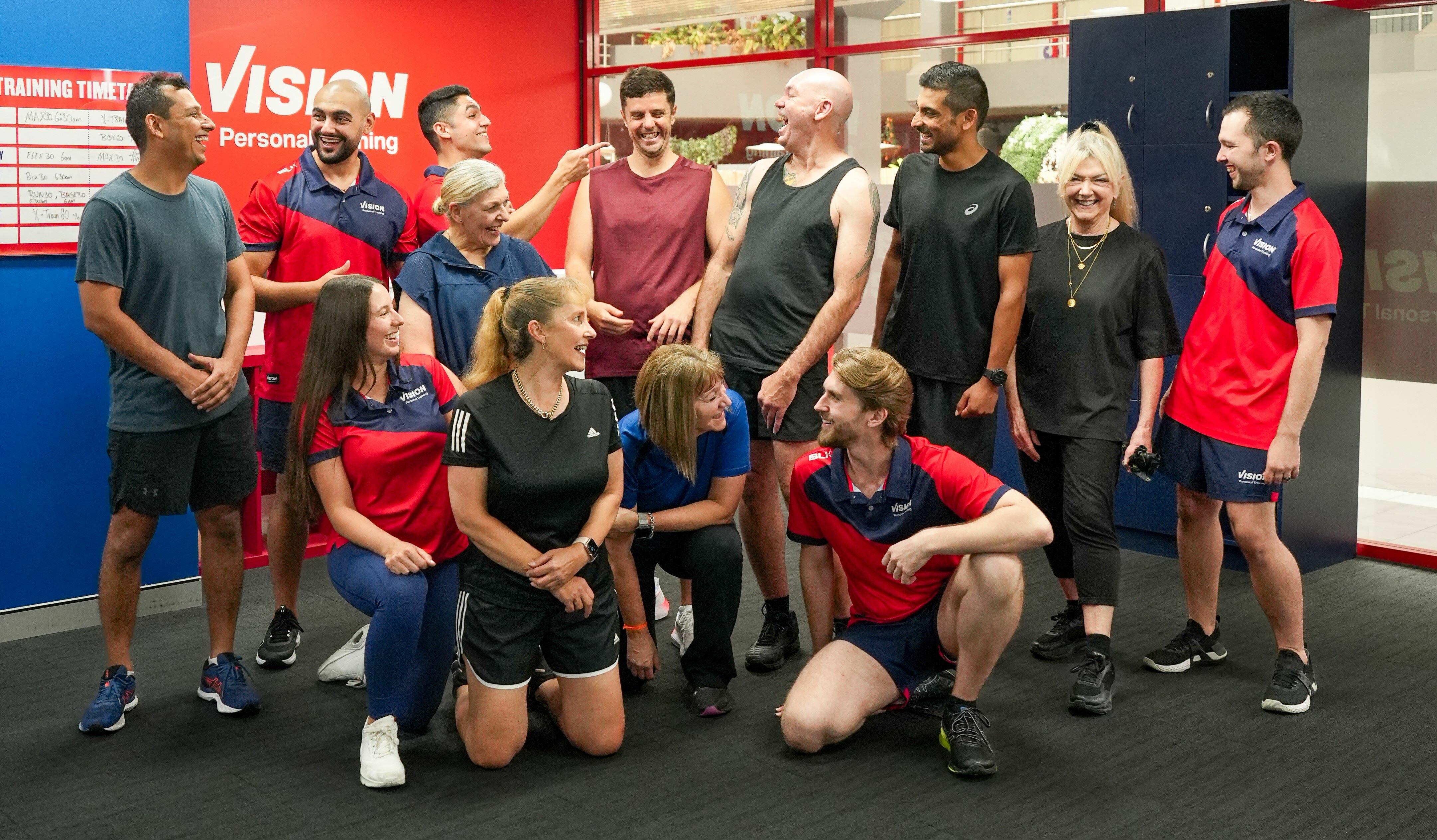 Vision Personal Training clients celebrating long-term health and fitness success together as a supportive community.